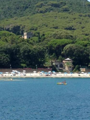 a group of people in a boat in the water at Castello Bellariva with Swimming Pool and Tennis Court in Cavo
