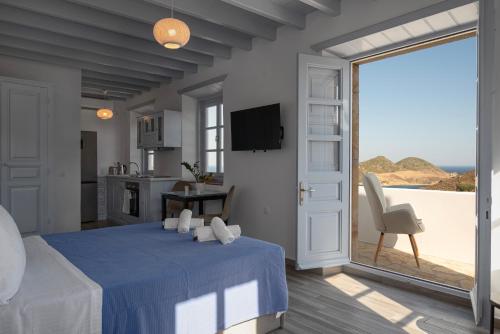 a bedroom with a bed with a view of the ocean at Apartment Nektarios in Grikos