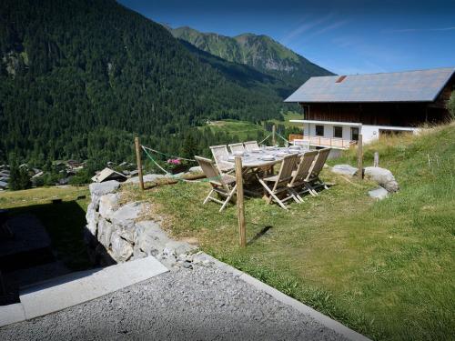 a table and chairs in front of a house at Chalet Wanderlust - OVO Network in Châtel