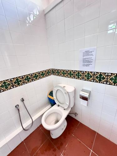 a bathroom with a white toilet in a stall at 26 Rangoon Residence 26 in George Town