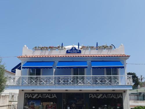 a blue and white building with a balcony at Blu D Alia Exclusive Rooms in Ischia