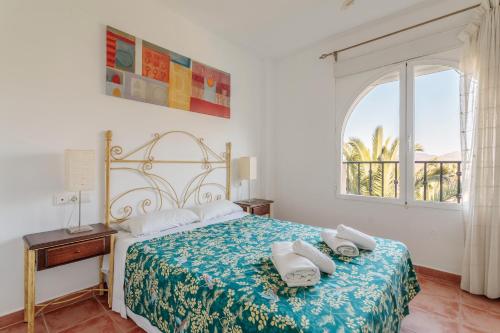 une chambre avec un lit avec deux serviettes dessus dans l'établissement Las Lomas de Bonalba, à Mutxamel