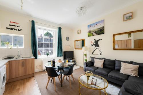 a living room with a couch and a table at STR8BS8 Georgian 2-Bedroom Apartment, Clifton, Parking & Garden in Bristol