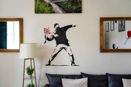 a drawing of a man on a wall in a living room at STR8BS8 Georgian 2-Bedroom Apartment, Clifton, Parking & Garden in Bristol