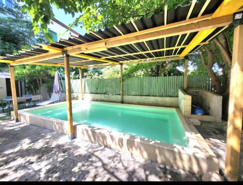 une piscine avec une pergola et une piscine dans l'établissement Appartement détente avec jacuzzi et piscine, à Perpignan
