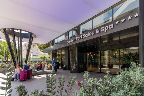 a group of people sitting outside of a building at Golden Port Salou & Spa in Salou