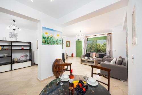 a living room with a table and a couch at Villa Poseidonia in Katelios