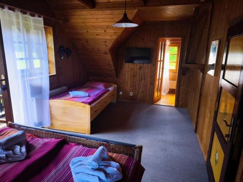 a bedroom with two beds in a wooden cabin at Kalahari Klínovec in Loučná pod Klínovcem