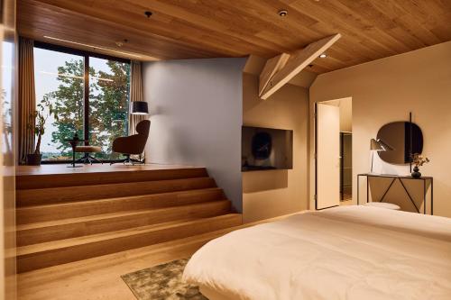 a bedroom with a bed and a desk and a window at Heritage Hotel Kurija Mihalović in FeriÄanci