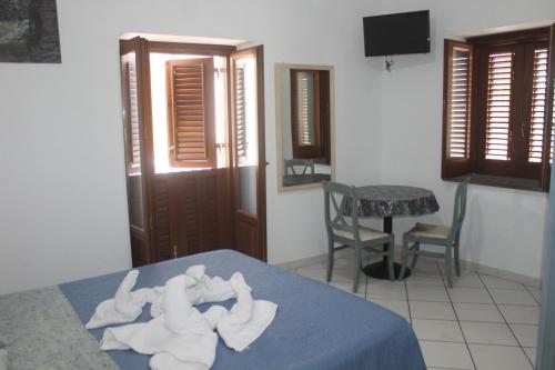 a room with a bed with folded towels on it at Case Vacanze S. Anna in Lipari