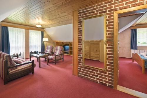 a room with a brick wall and chairs and a table at Hotel Resort Martin & Kristyna in Špindlerův Mlýn