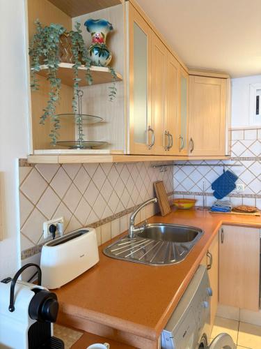 a kitchen with a sink and a counter top at Alegre Beach Home - Sunset Apartment in Arguineguín