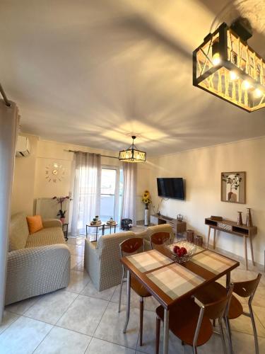 a living room with a table and a couch at Sunflower in Loutra Edipsou