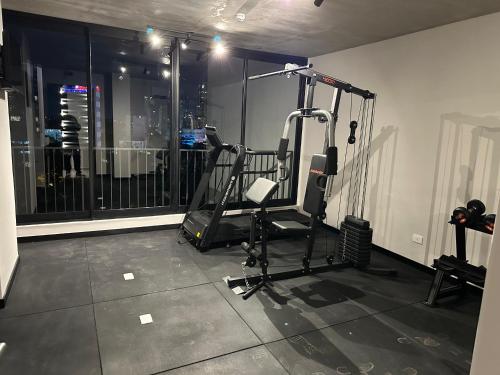 a room with a gym with a treadmill at First del Sol in Asuncion