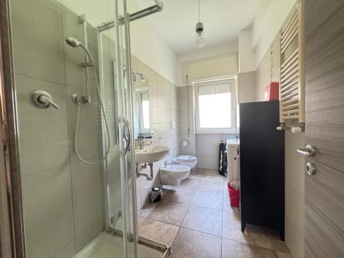 a bathroom with a shower and a toilet and a sink at CASA Degli ARTISTI in Acilia
