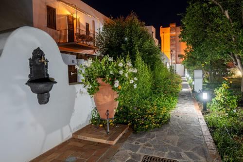 a vase filled with flowers sitting on a wall at Case Vacanze S. Anna in Lipari