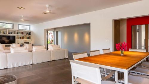 a dining room with a table and white chairs at Marigot Bay Oasis with Infinity Pool in Marigot