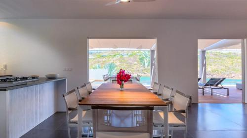 a dining room with a wooden table and chairs at Marigot Bay Oasis with Infinity Pool in Marigot