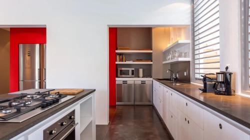 a kitchen with a stove and a counter top at Marigot Bay Oasis with Infinity Pool in Marigot