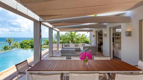 a dining room with a view of the ocean at Marigot Bay Oasis with Infinity Pool in Marigot