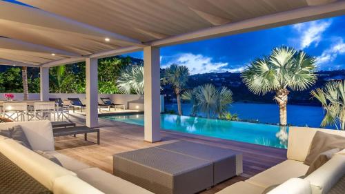 a living room with a view of the water at Marigot Bay Oasis with Infinity Pool in Marigot