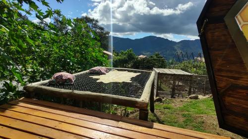 a bird bath sitting on a deck with a fountain at Chalé Refugio da Pedra SP in São Bento do Sapucaí