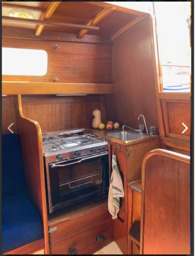 a small kitchen with a stove and a sink at Bily Boat Praia da Rocha Portimão in Portimão