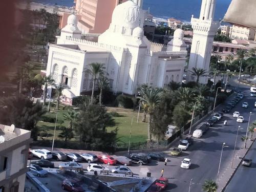 a large white building with a parking lot in front of it at طرح البحر بورسعيد in Port Said