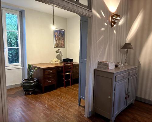 a home office with a desk and a lamp at Le relais 1850 in Creuzier-le-Vieux