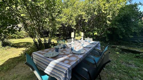 a long table with plates and glasses on it at Le relais 1850 in Creuzier-le-Vieux
