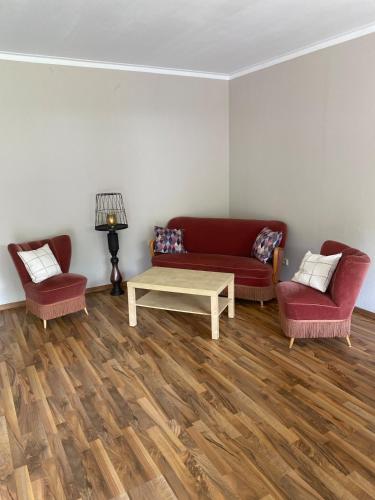 a living room with two couches and a coffee table at Ferienhaus im Grünen in Bad Hersfeld