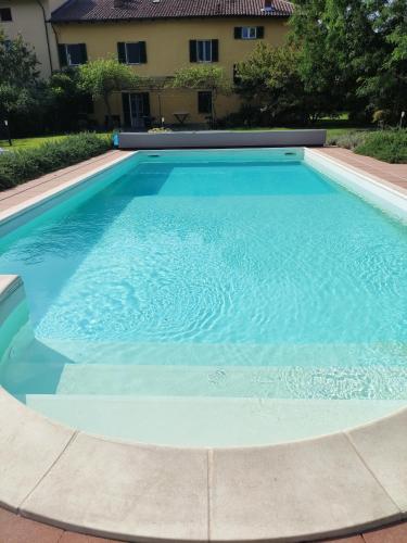 a large swimming pool with blue water at Bed&Breakfast Villa Camilla in Ivrea