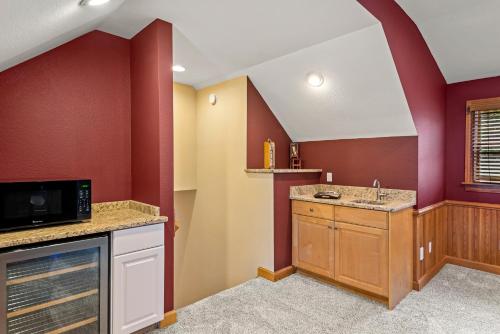a kitchen with a sink and a microwave at Beach ParTee Time in Corolla