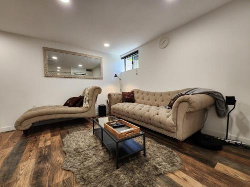 a living room with a couch and a table at HomeSmart: Cozy Charm Meets High-Tech in Prime Area in Seattle