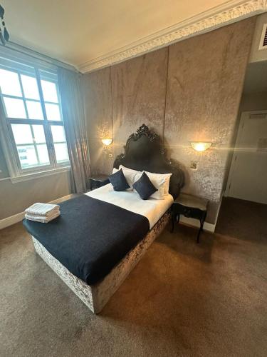 a bedroom with a large bed in a room with a window at White Star Line Hotel in Liverpool