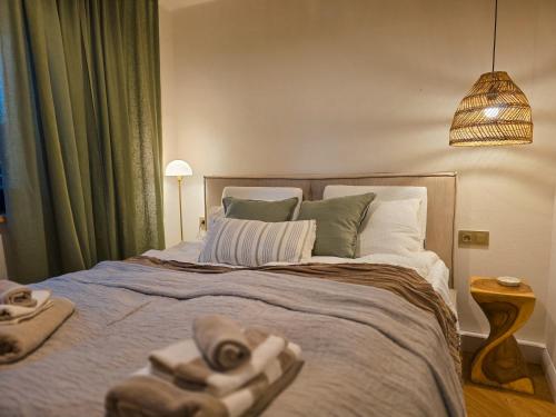 a bedroom with a large bed with towels on it at Haus Kleinod in Bodensdorf