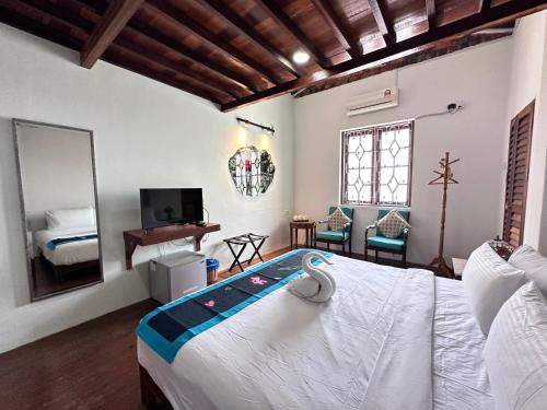 a bedroom with a large bed and a mirror at 26 Rangoon Residence 26 in George Town