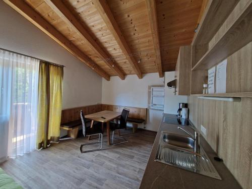 a kitchen with a table and a dining room at Appartement St. Hubertus in Flirsch