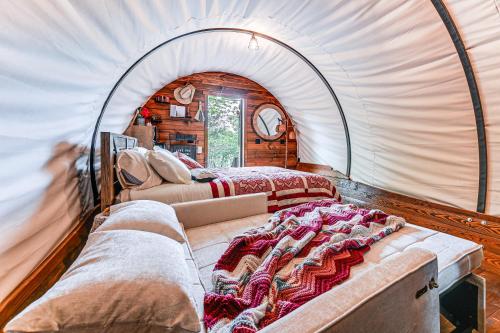 a room with two beds in a tent at Covered Wagon Vacation Rental in Broken Bow! in Broken Bow