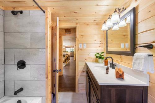 a bathroom with a shower and a sink at 2 Mi to Dtwn Spacious Gatlinburg Home with Hot Tub! in Gatlinburg