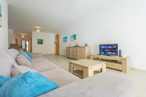 a living room with a couch and a tv at Private Terrace 3BR Home Near Bay & Promenade by QuickTrips in St. Paul's Bay