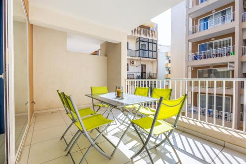 a balcony with a table and chairs on a building at Private Terrace 3BR Home Near Bay & Promenade by QuickTrips in St. Paul's Bay