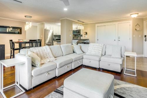 a living room with a white couch and a kitchen at 1 Mi to Millyard District Unit with Furnished Porch in Manchester