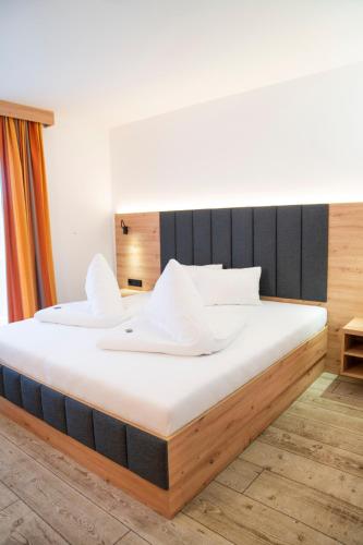 two beds in a room with a large mattress at Hotel Alpina in Kleinarl