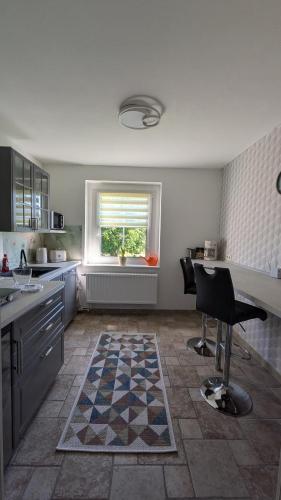 a kitchen with a table and chairs and a window at FeWo Ertel in Hennigsdorf