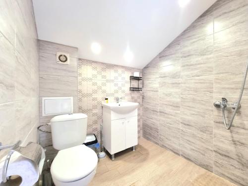 a bathroom with a toilet and a sink and a shower at Relax & Spa-House near Therma Numera in Burgas City