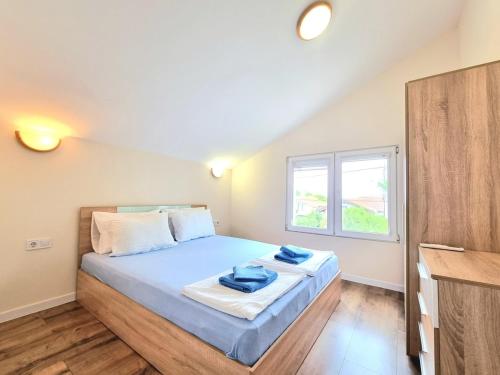 a bedroom with a bed with blue towels on it at Relax & Spa-House near Therma Numera in Burgas City