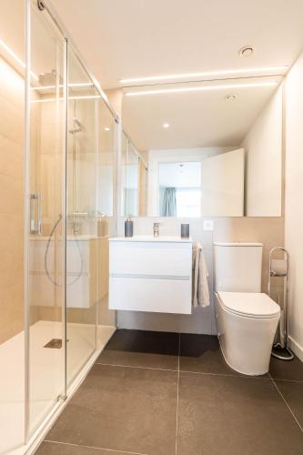 a bathroom with a sink and a toilet and a shower at Bext Valdebebas in Madrid