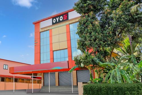 an office building with a qooc sign on it at Hotel O NILA TOURIST HOME in Trivandrum