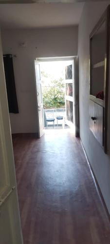 an empty room with an open door to a patio at Palms View Villa in Mount Ābu
